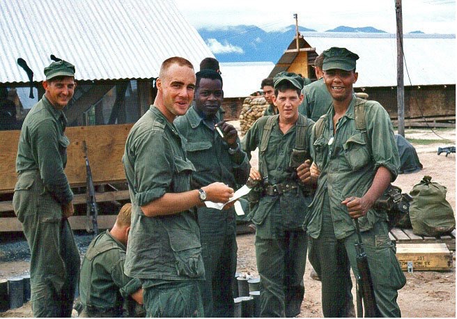 Photo of 2d Lt. John P. Bobo reading a letter from home to fellow Marines, November 1966. (Posted to VVMF courtesy of Jack Riley)
